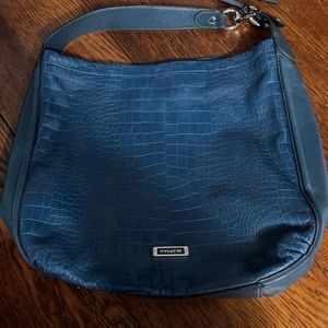 Teal , leather Coach bag .